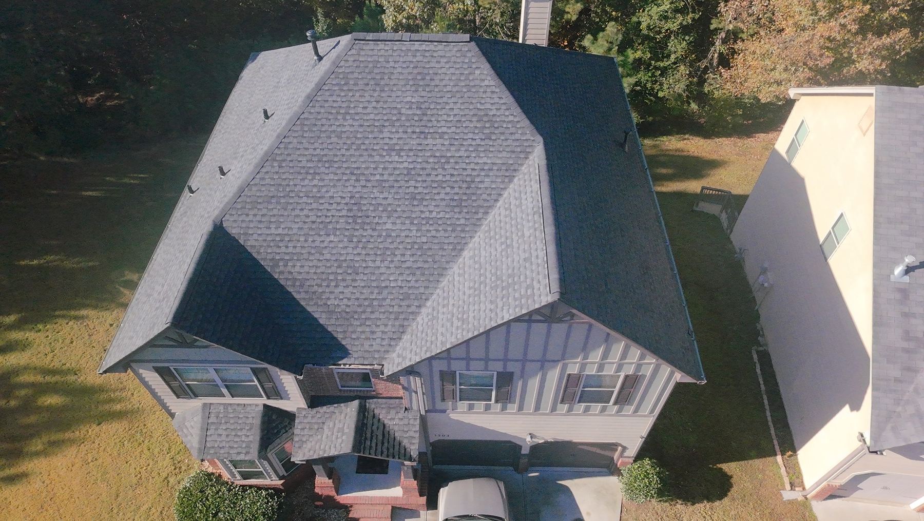Residential roof surrounded by trees